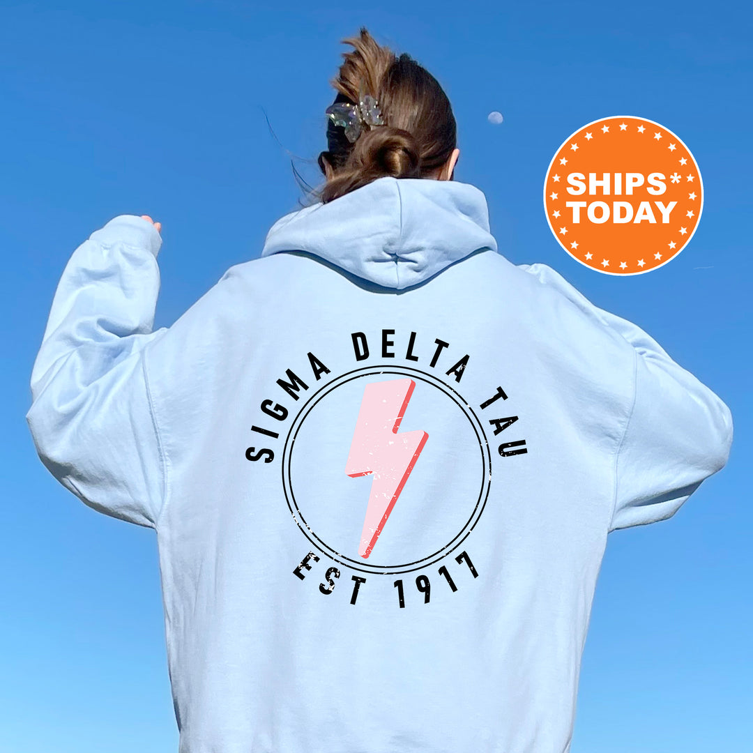 a woman wearing a white sweatshirt with a lightning bolt on it