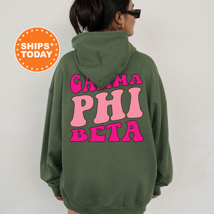 a woman wearing a green hoodie with pink letters