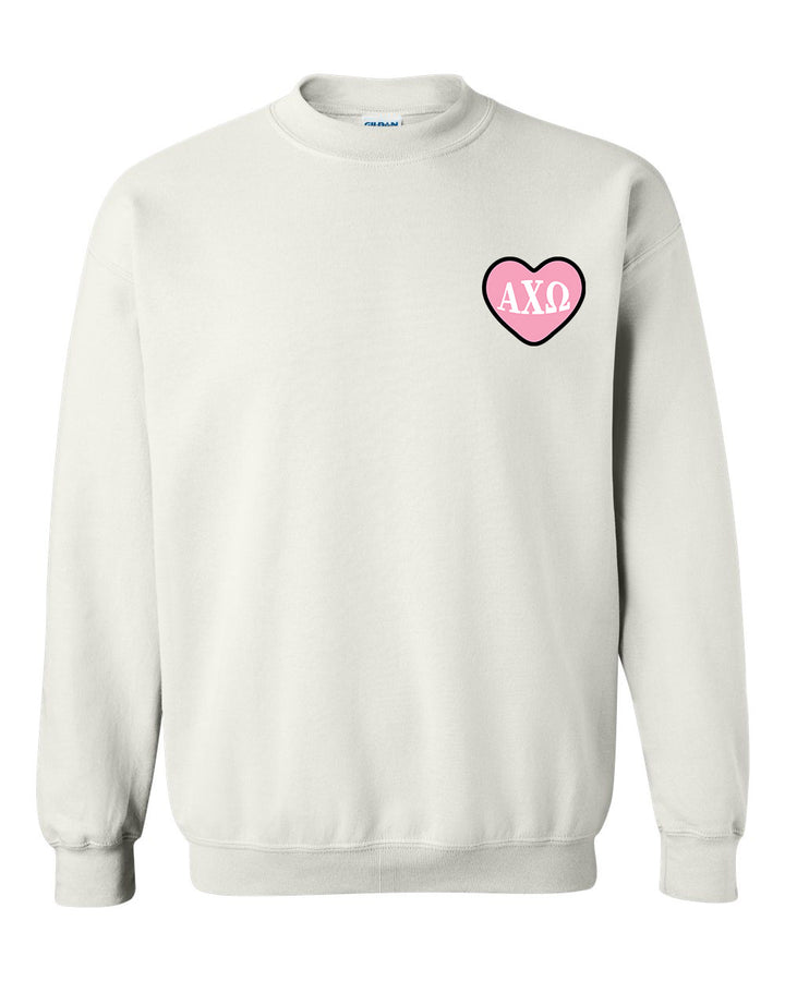 a white sweatshirt with a pink heart on the chest