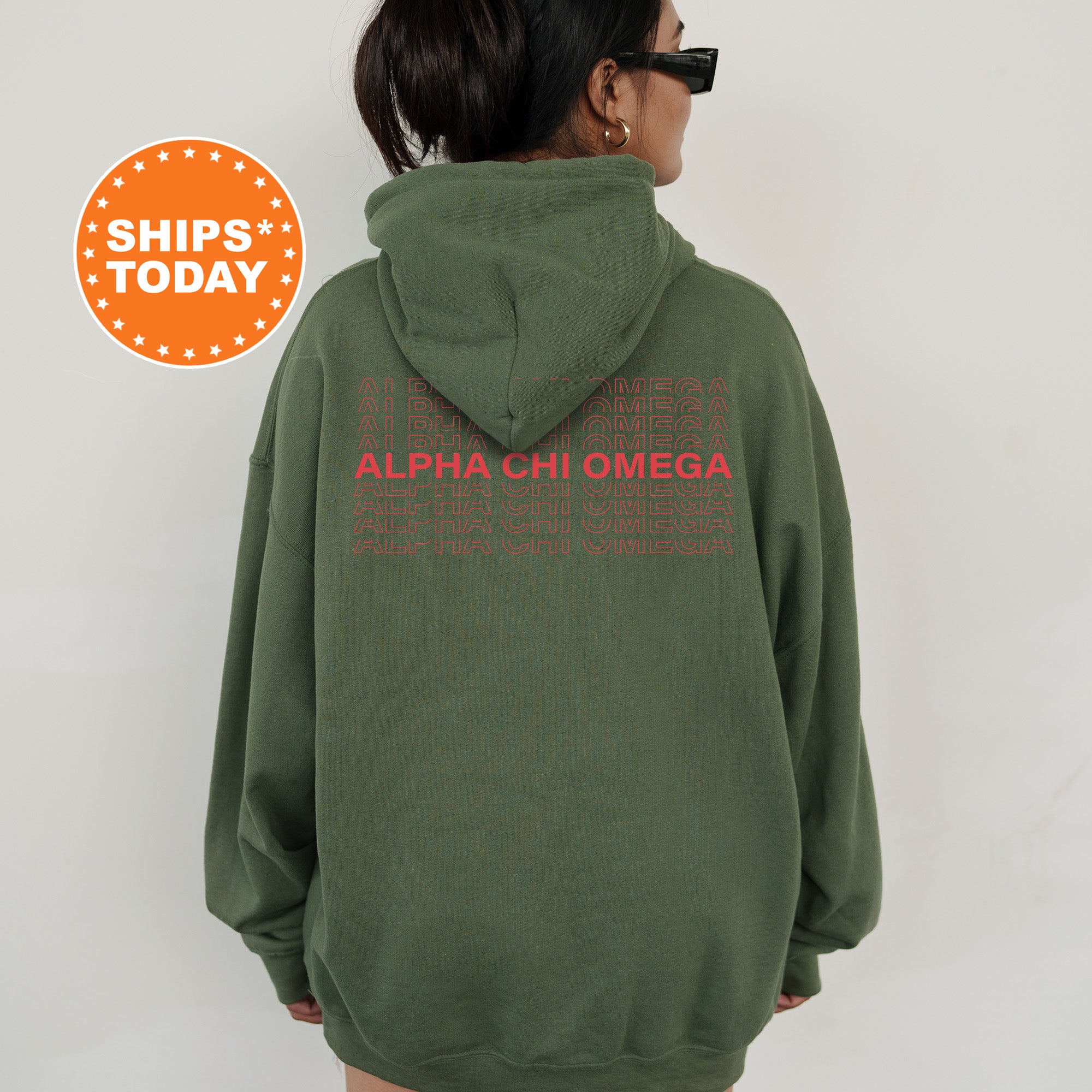 a woman wearing a green hoodie with a red graphic on it