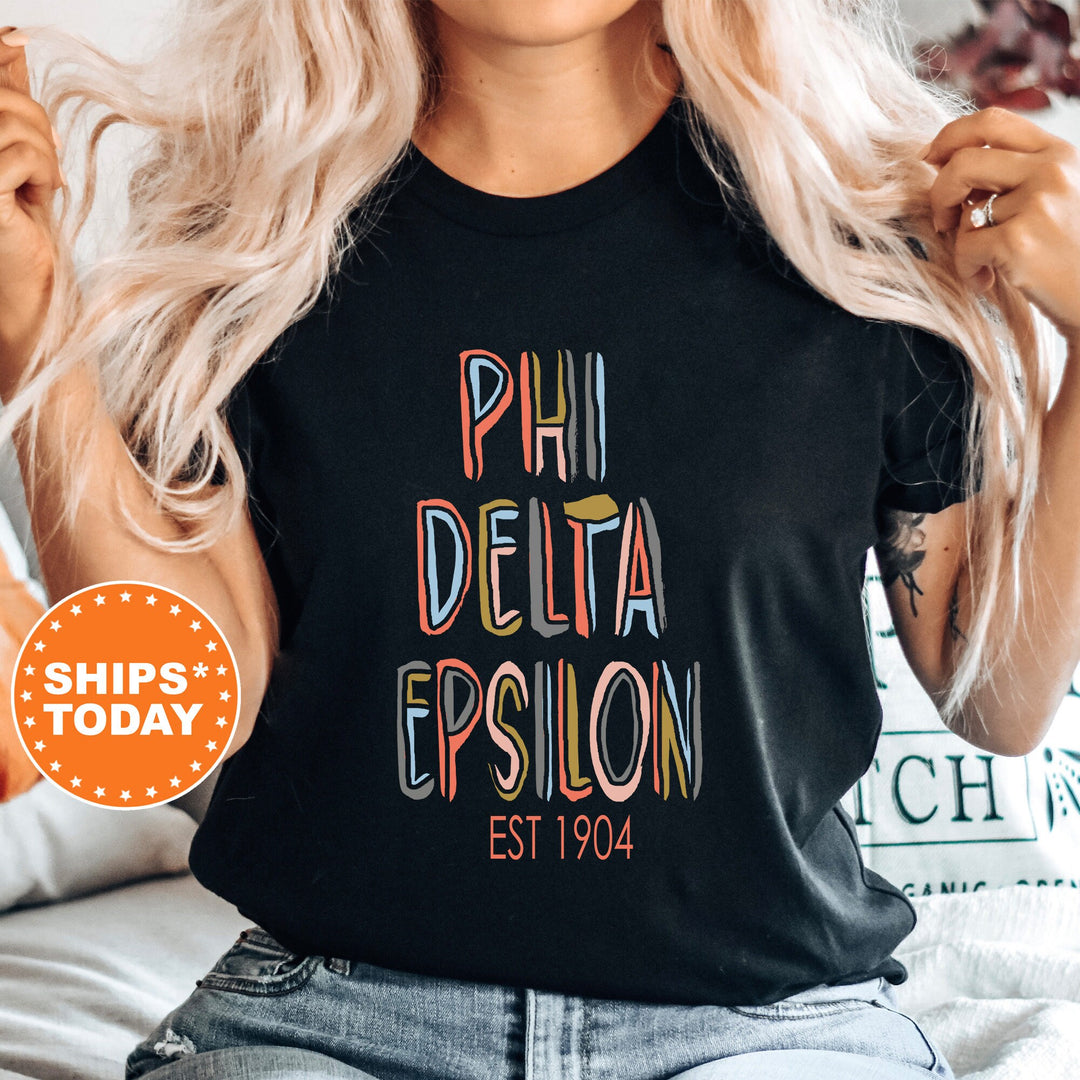 Phi Delta Epsilon Pastel Stencil Coed T-Shirt | PhiDE Fraternity Shirt | Greek Apparel | Medical Fraternity | Comfort Colors Shirt _ 8841g