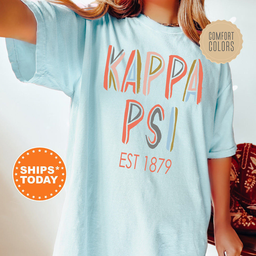 Kappa Psi Pastel Stencil Coed T-Shirt | Kappa Psi Comfort Colors Shirt | Fraternity Apparel | Bid Day Gift | Custom Greek Apparel _ 8837g