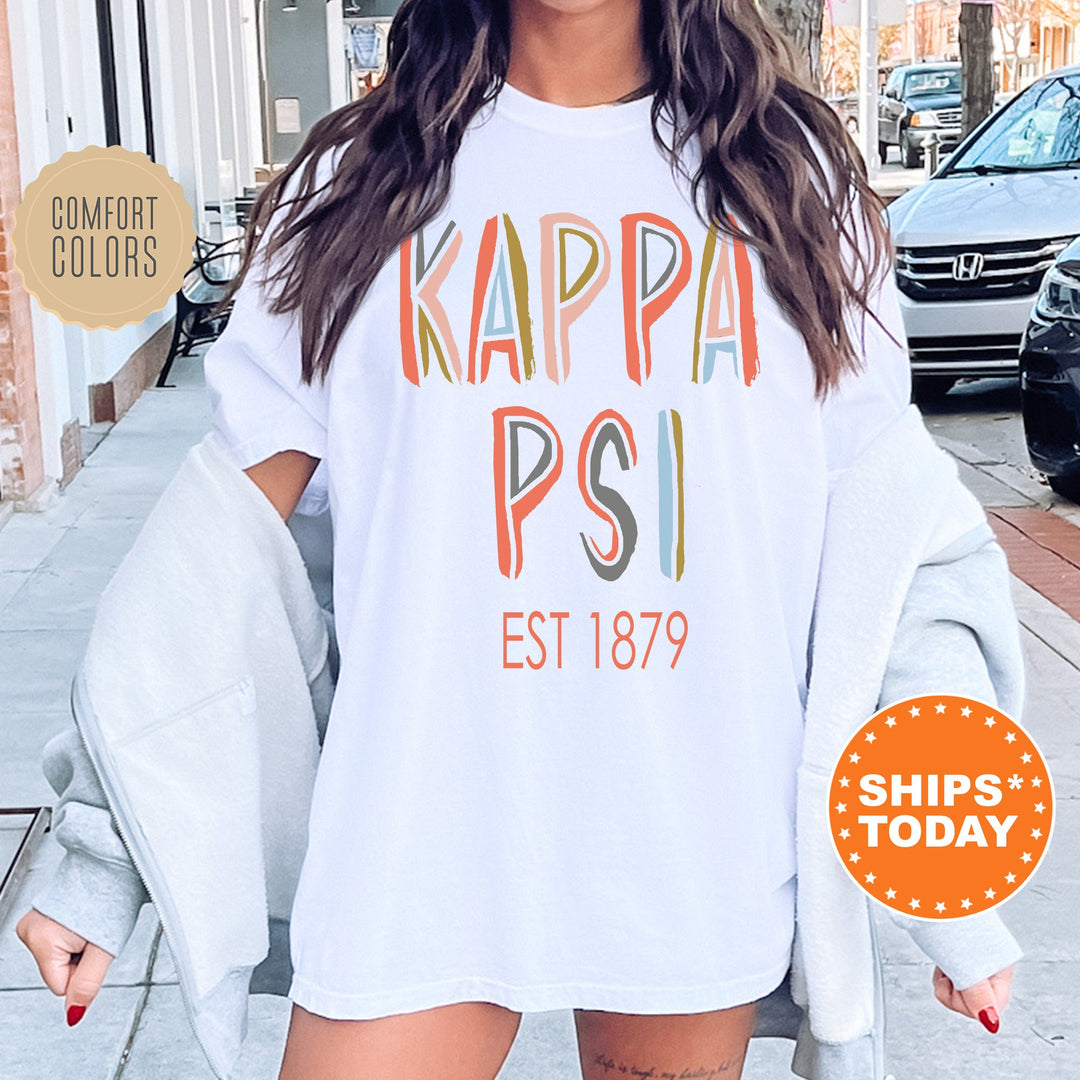 Kappa Psi Pastel Stencil Coed T-Shirt | Kappa Psi Comfort Colors Shirt | Fraternity Apparel | Bid Day Gift | Custom Greek Apparel _ 8837g