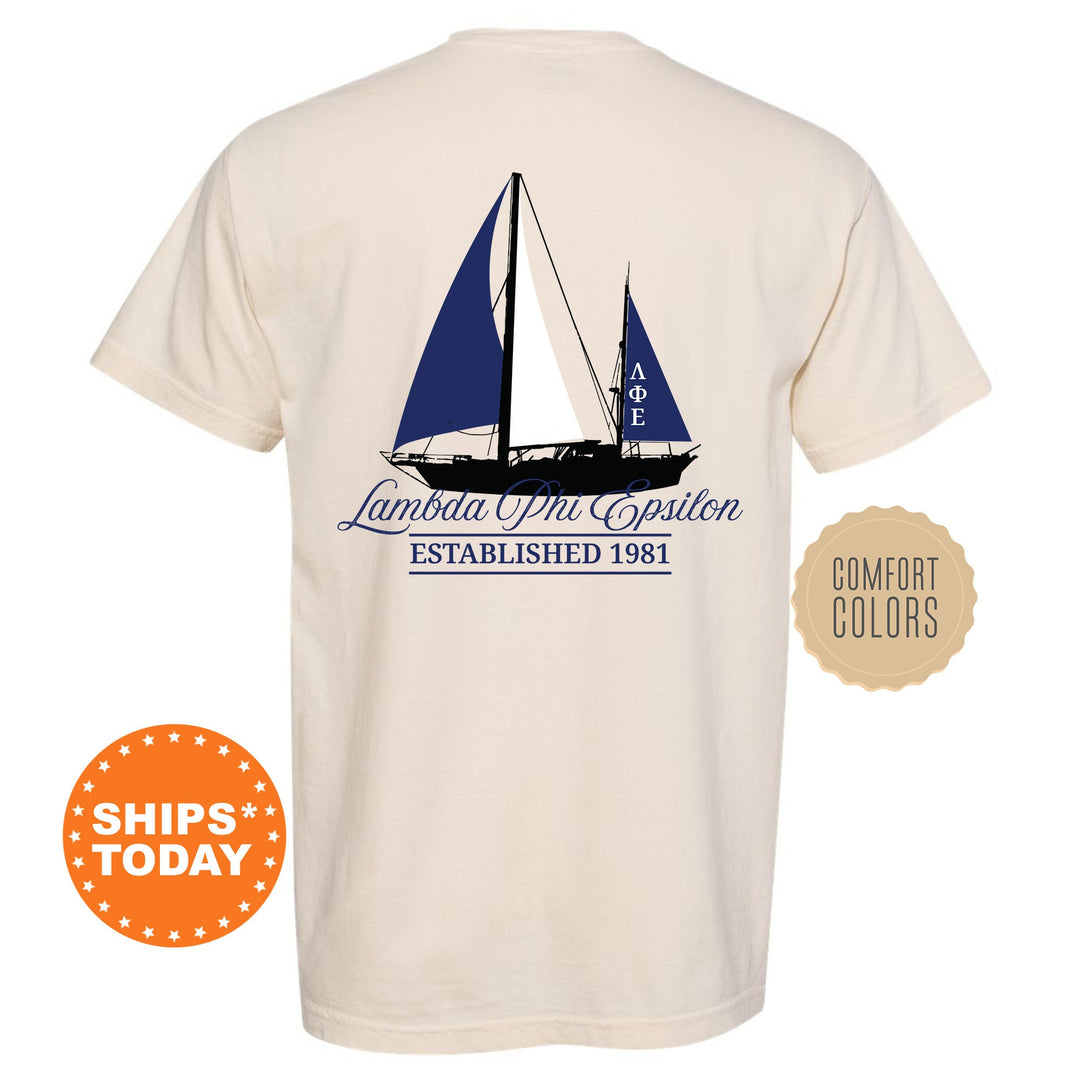 a white shirt with a blue sailboat on it