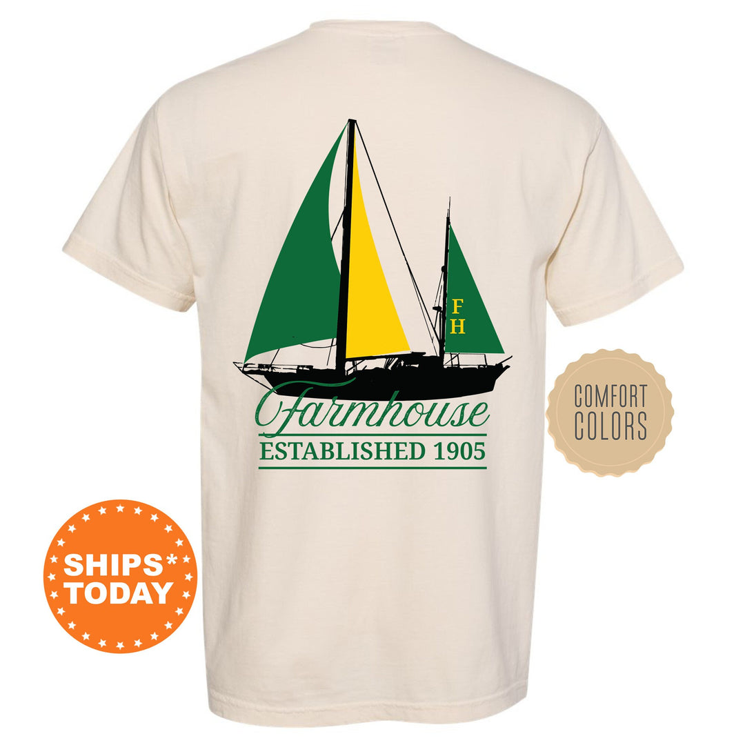 a white t - shirt with a green and yellow sailboat