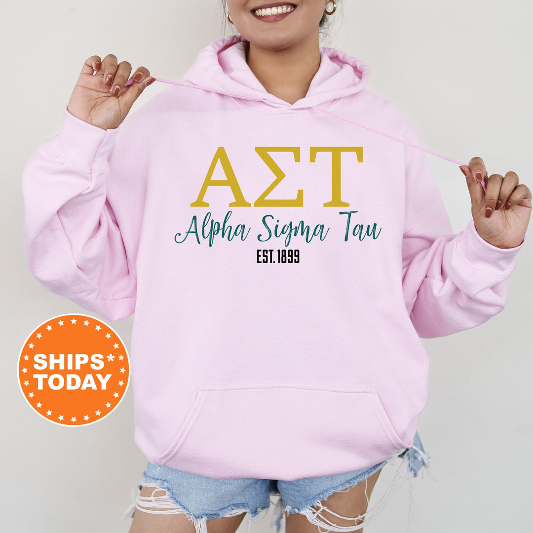a woman wearing a pink hoodie with the word azt on it