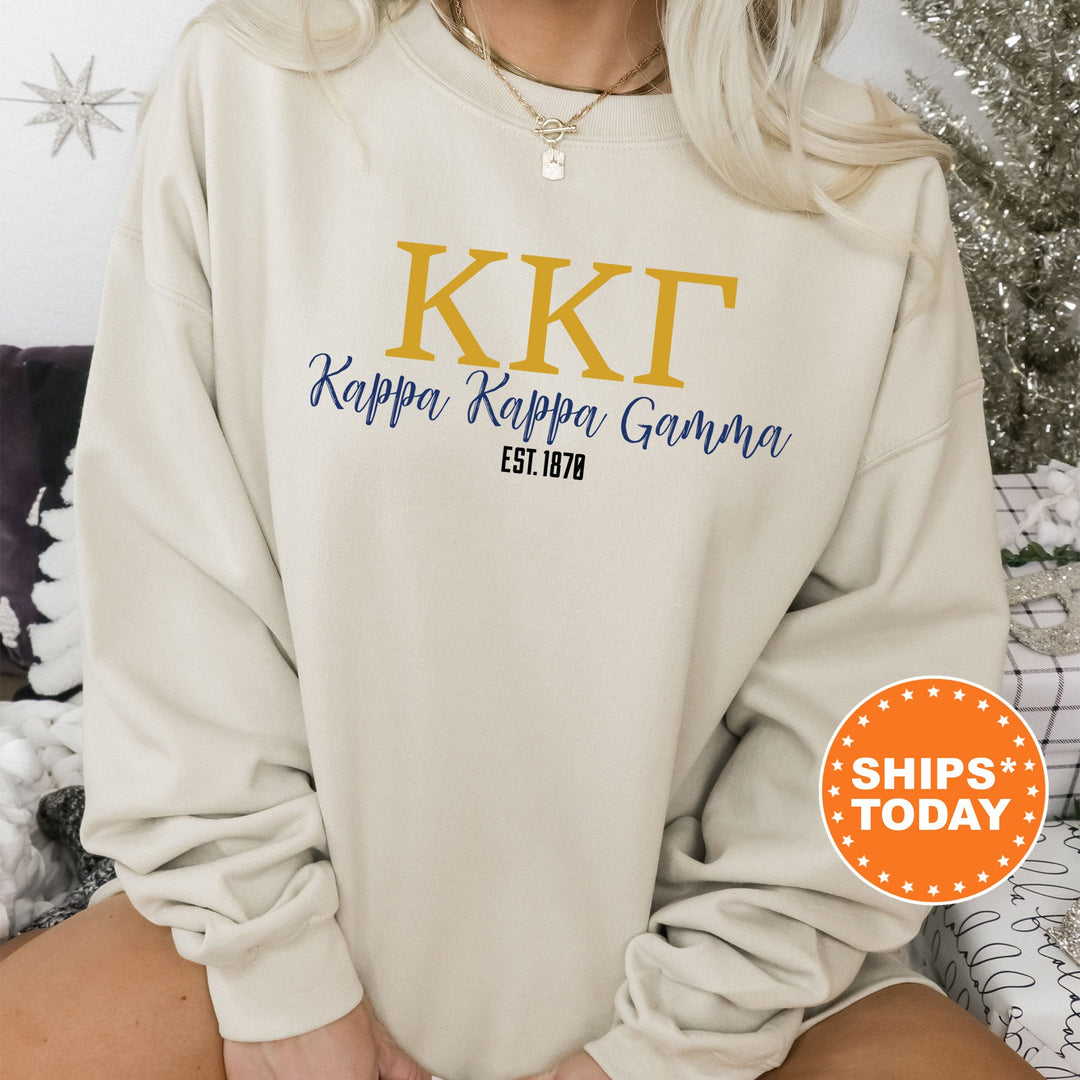 a woman sitting on a couch wearing a kkt sweatshirt