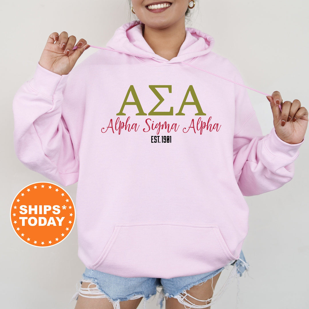 a woman wearing a pink hoodie with the word&#39;aza&#39;on it