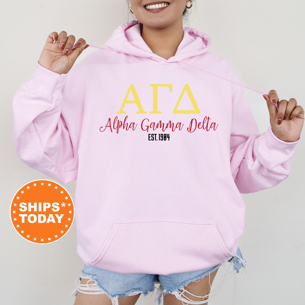 a woman wearing a pink hoodie with the letters ata on it