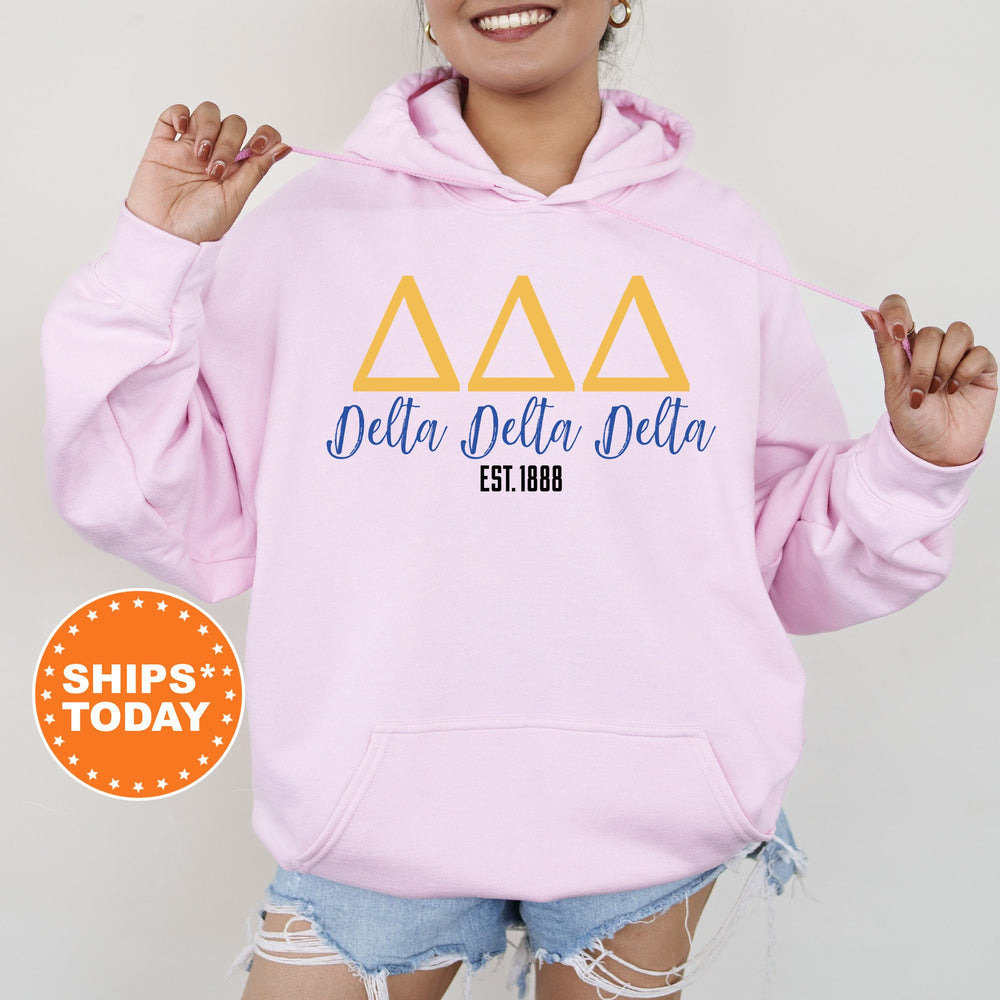 a woman wearing a pink delta delta hoodie