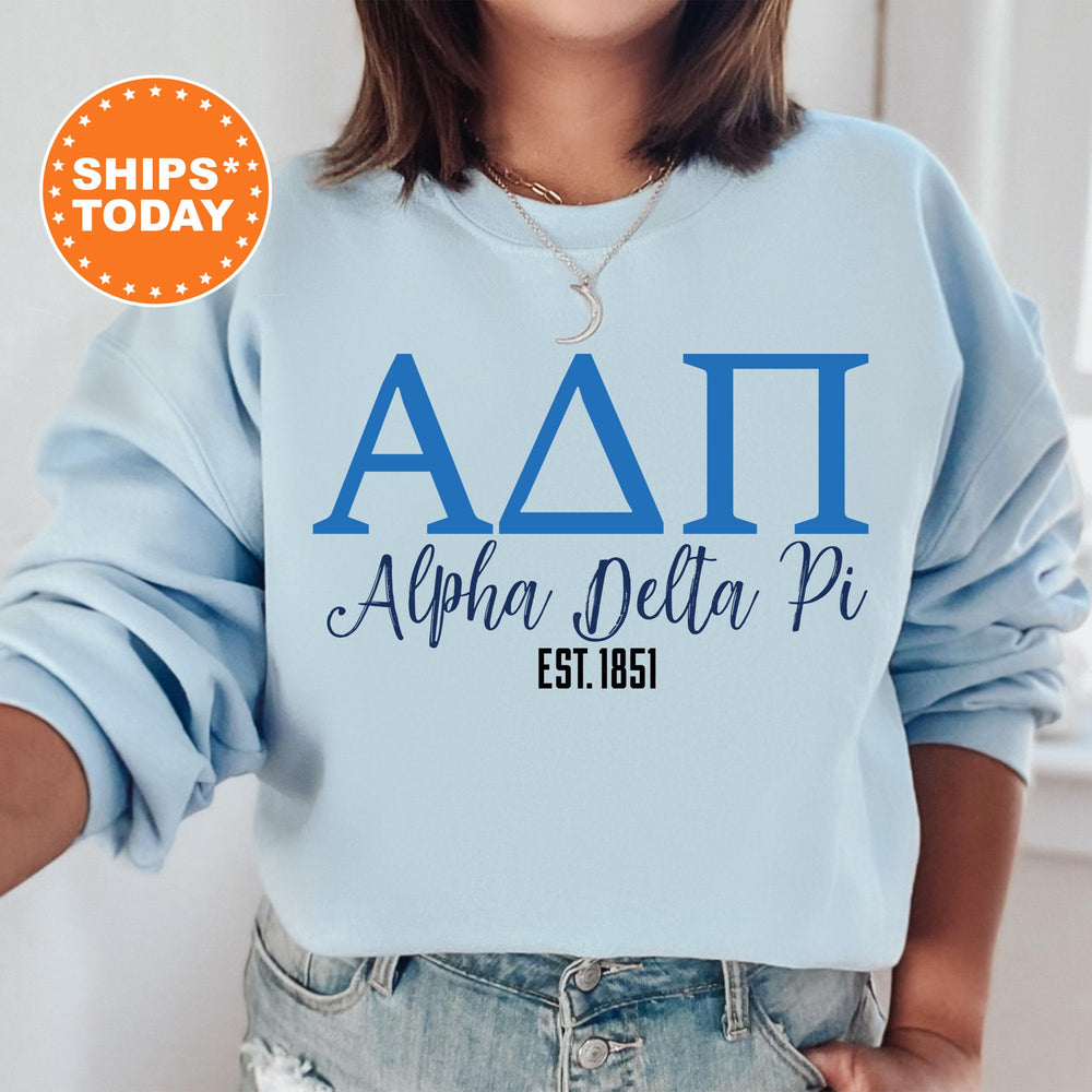 a woman wearing a blue sweatshirt with the letters aati and delta phi on it