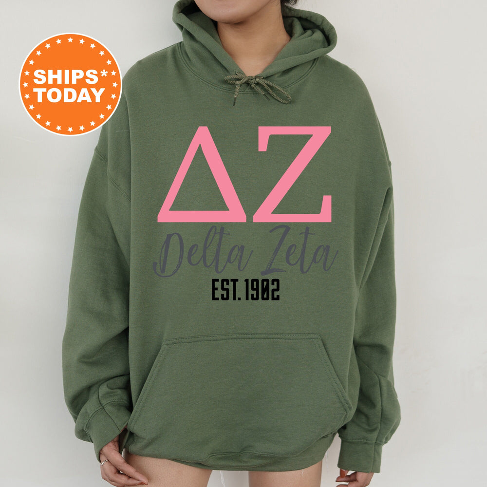 a woman wearing a green hoodie with pink letters