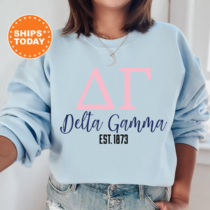 a woman wearing a light blue sweatshirt with the words delta gama printed on it