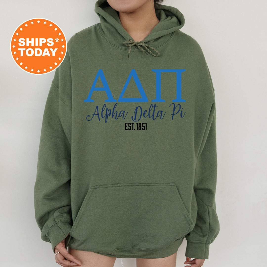 a woman wearing a green hoodie with blue letters on it