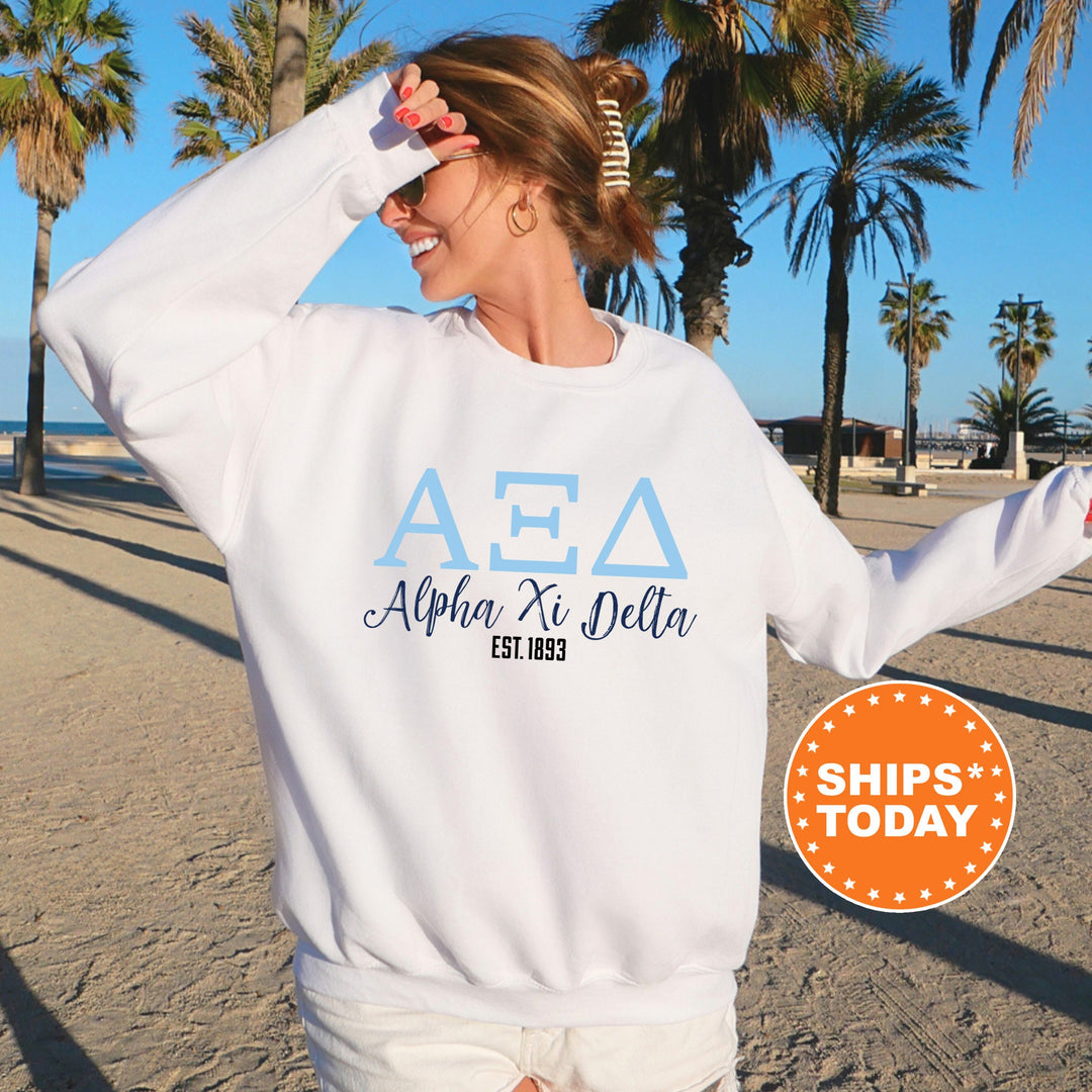 a woman wearing a white aea sweatshirt on the beach