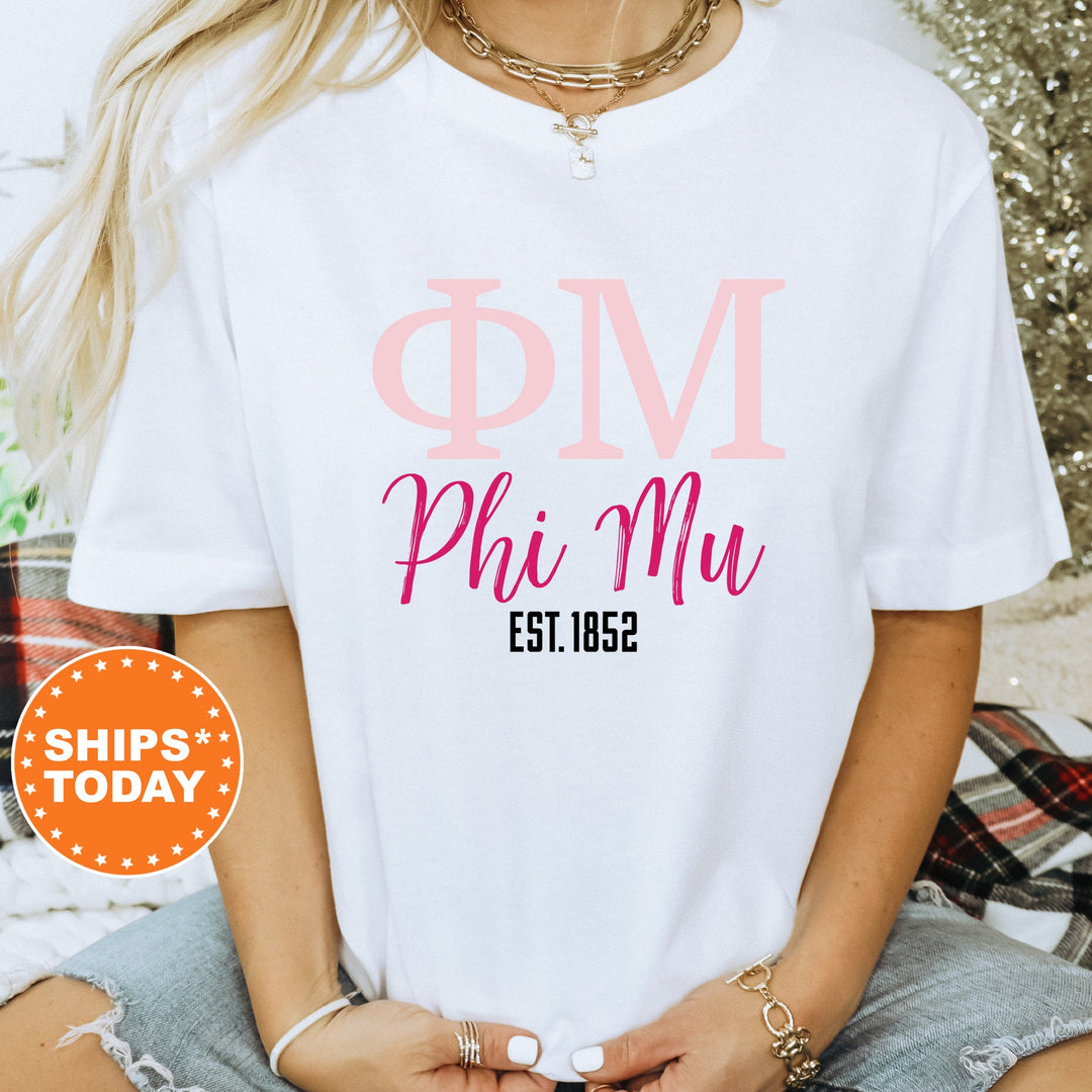 a woman wearing a t - shirt that says phi mu est 1932