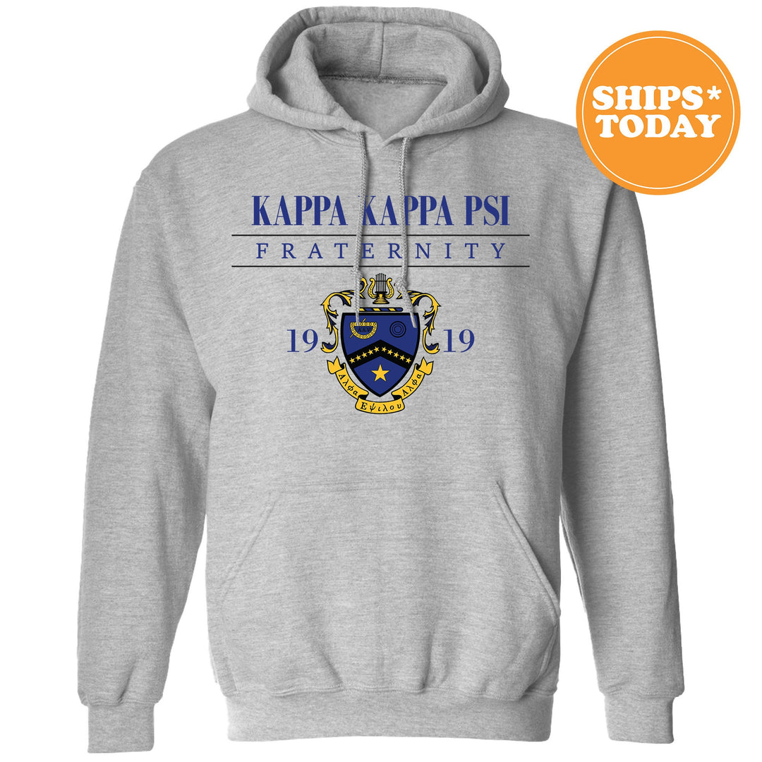 a grey hoodie with a blue and yellow crest on it