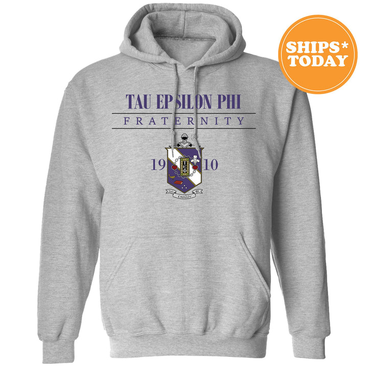 a grey hoodie with a purple and blue logo on it
