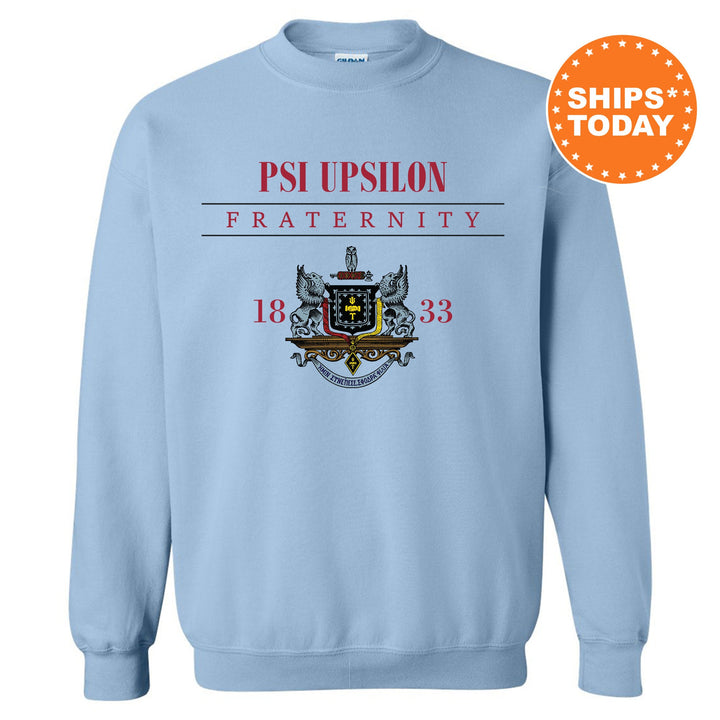 a light blue sweatshirt with a picture of a coat of arms and the words ps