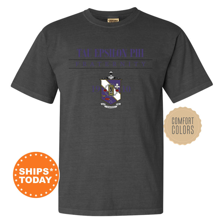 a black t - shirt with an image of a purple and blue shield on it