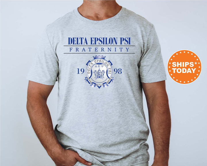 a man wearing a gray tshirt with the delta epsion psl fraternity