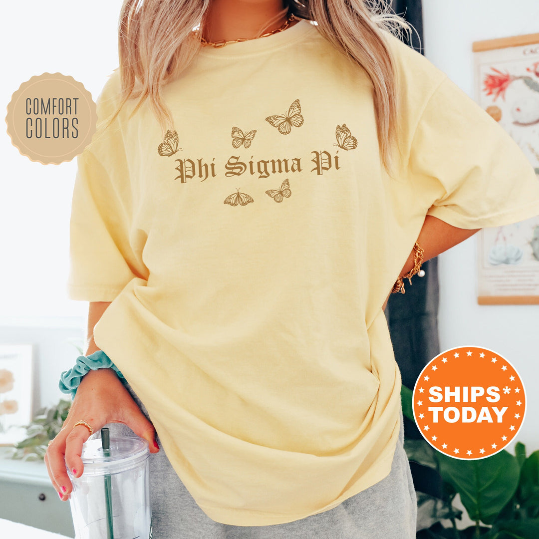 a woman wearing a yellow shirt with butterflies on it