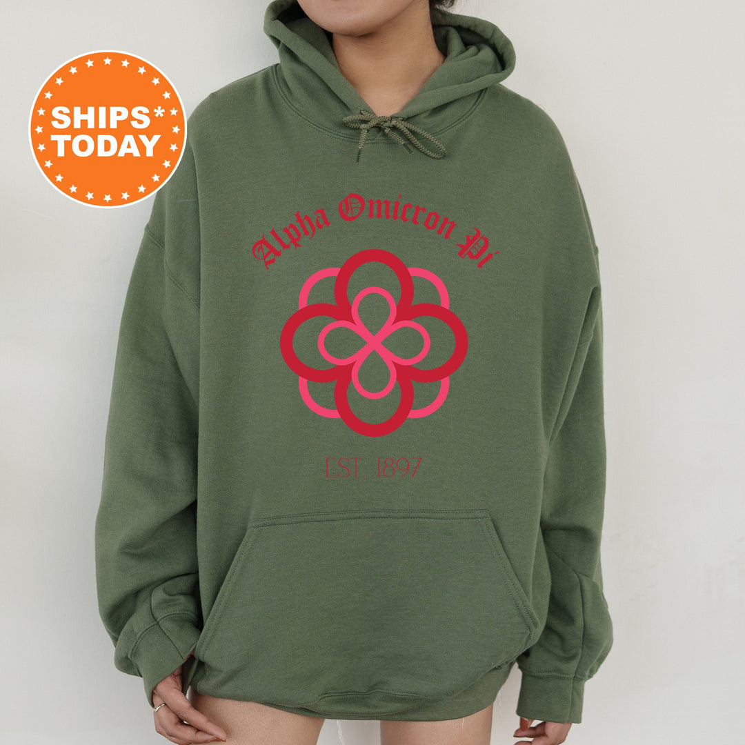 a person wearing a green hoodie with a red flower on it