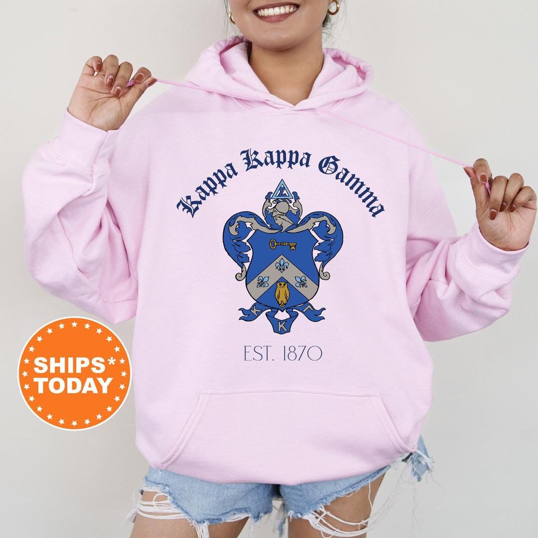 a woman wearing a pink hoodie with a crown on it