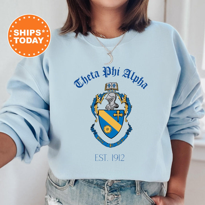 a woman wearing a blue sweatshirt with a crest on it