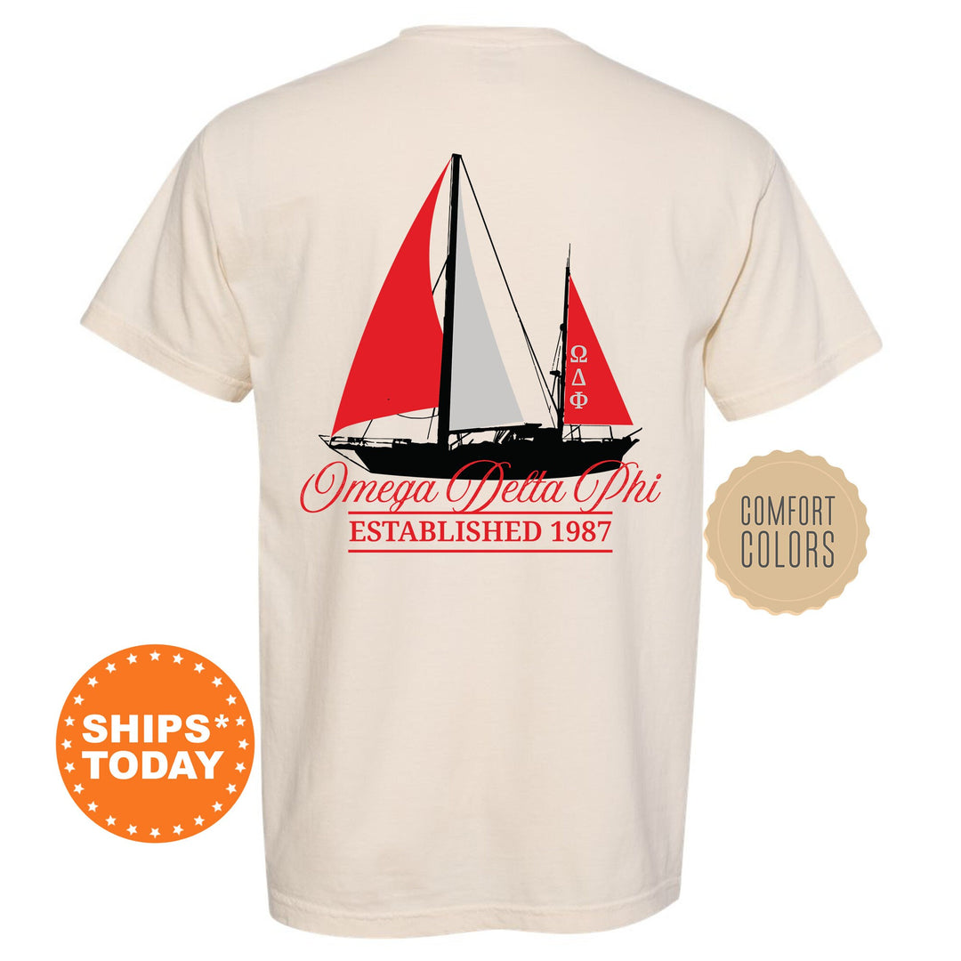 a white shirt with a red sailboat on it