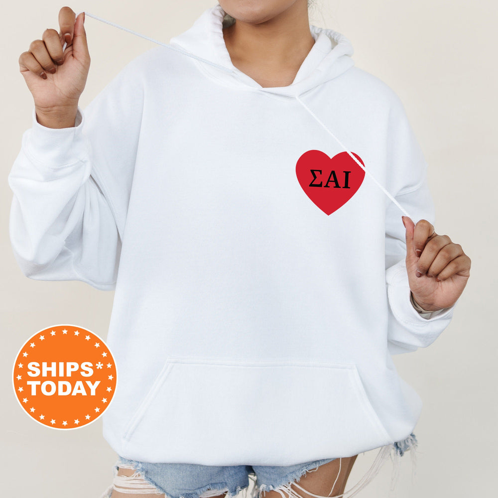 a woman wearing a white hoodie with a red heart on it