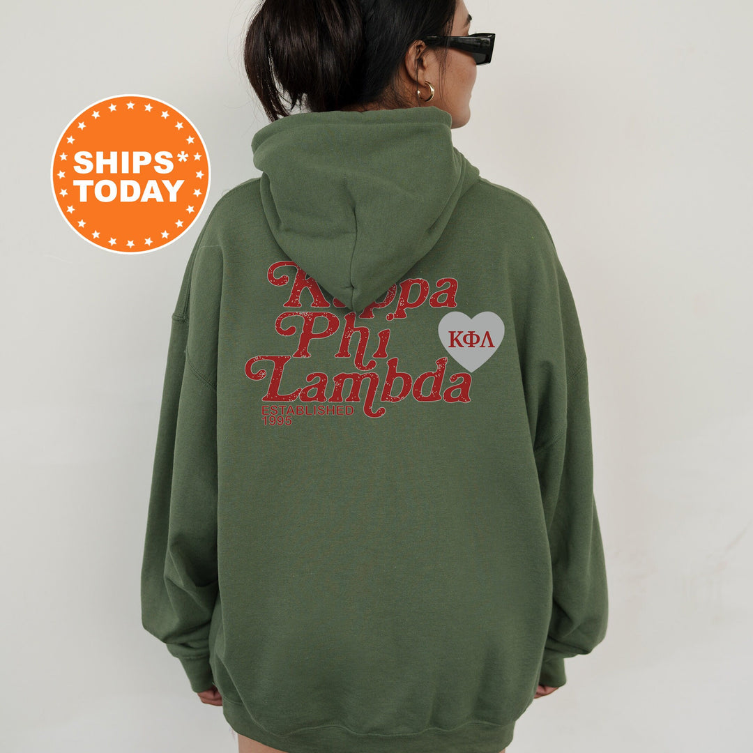 a woman wearing a green hoodie with a heart on it