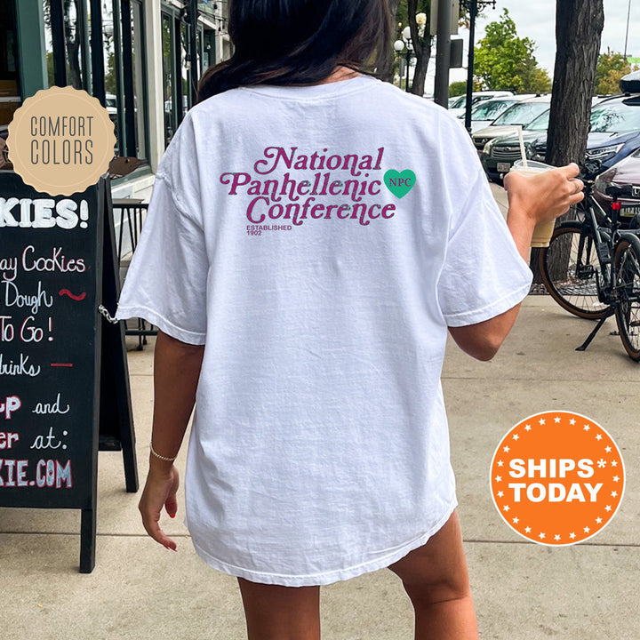 a woman walking down a sidewalk holding a cup of coffee