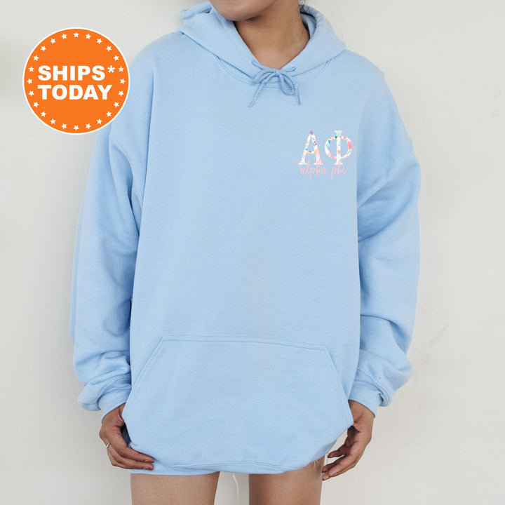 a person wearing a blue hoodie with a pink and white logo on it
