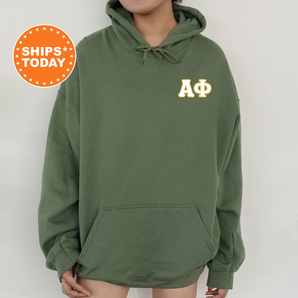 a woman wearing a green hoodie with a phi phi phi on it