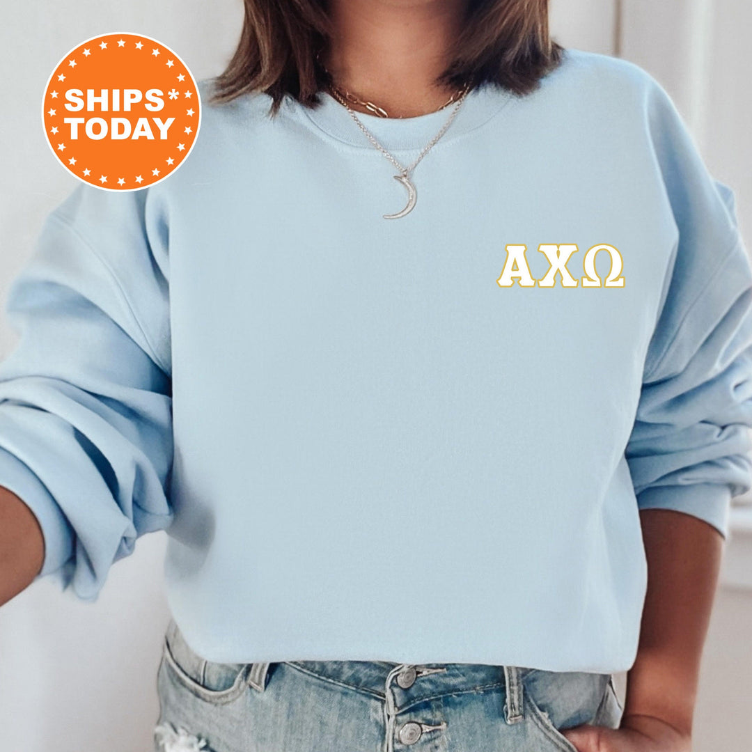 a woman wearing a light blue sweatshirt with the word axo printed on it