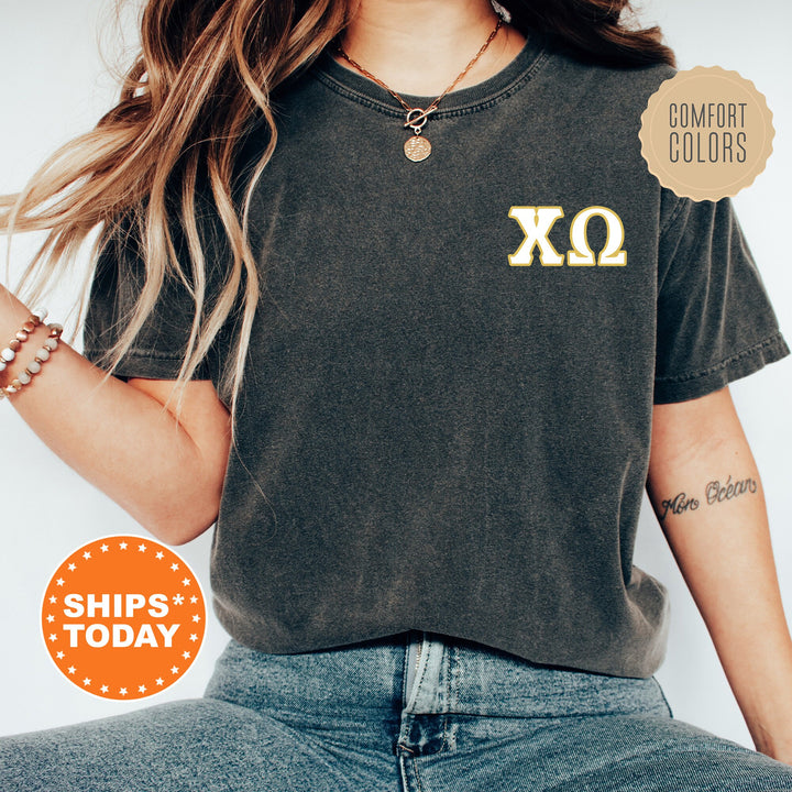 a woman wearing a black shirt with a yellow xo on it