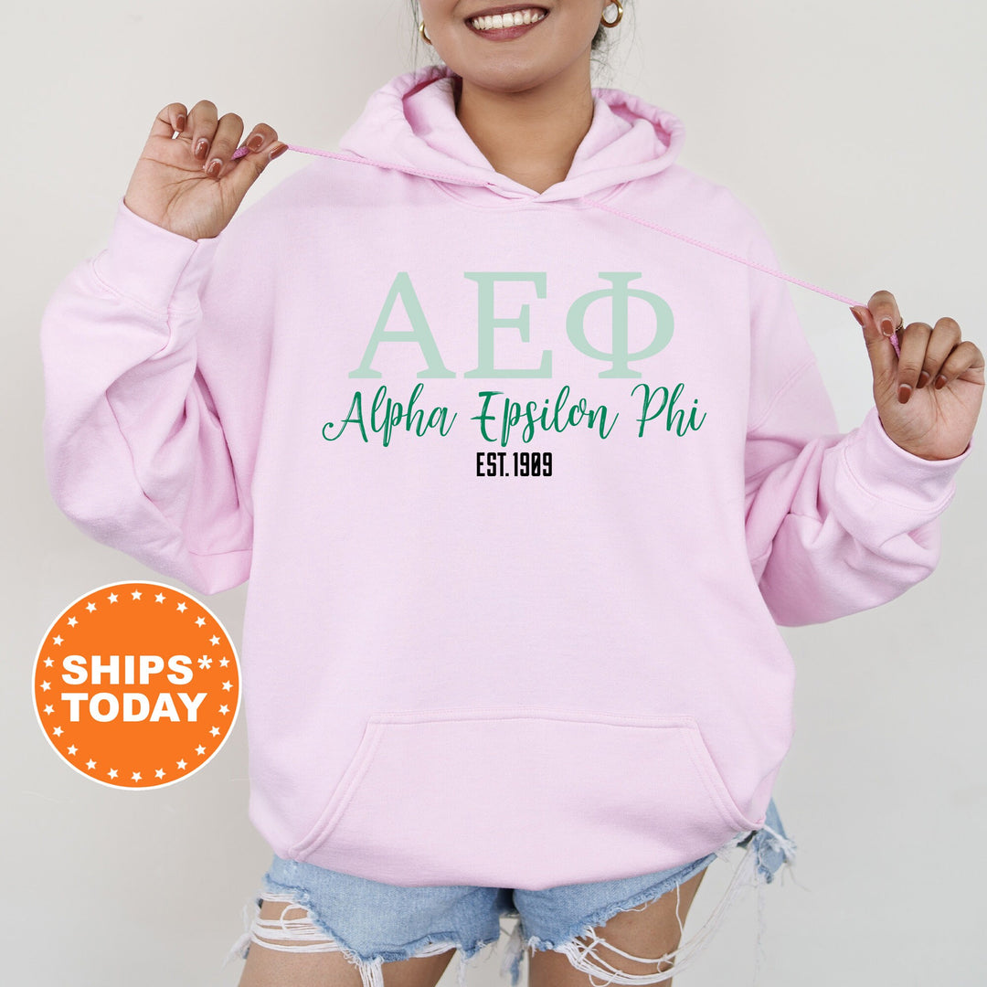 a woman wearing a pink hoodie with the words afq on it