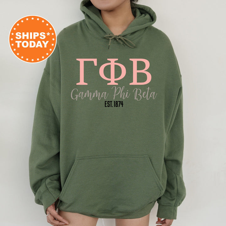 a woman wearing a green hoodie with pink letters on it