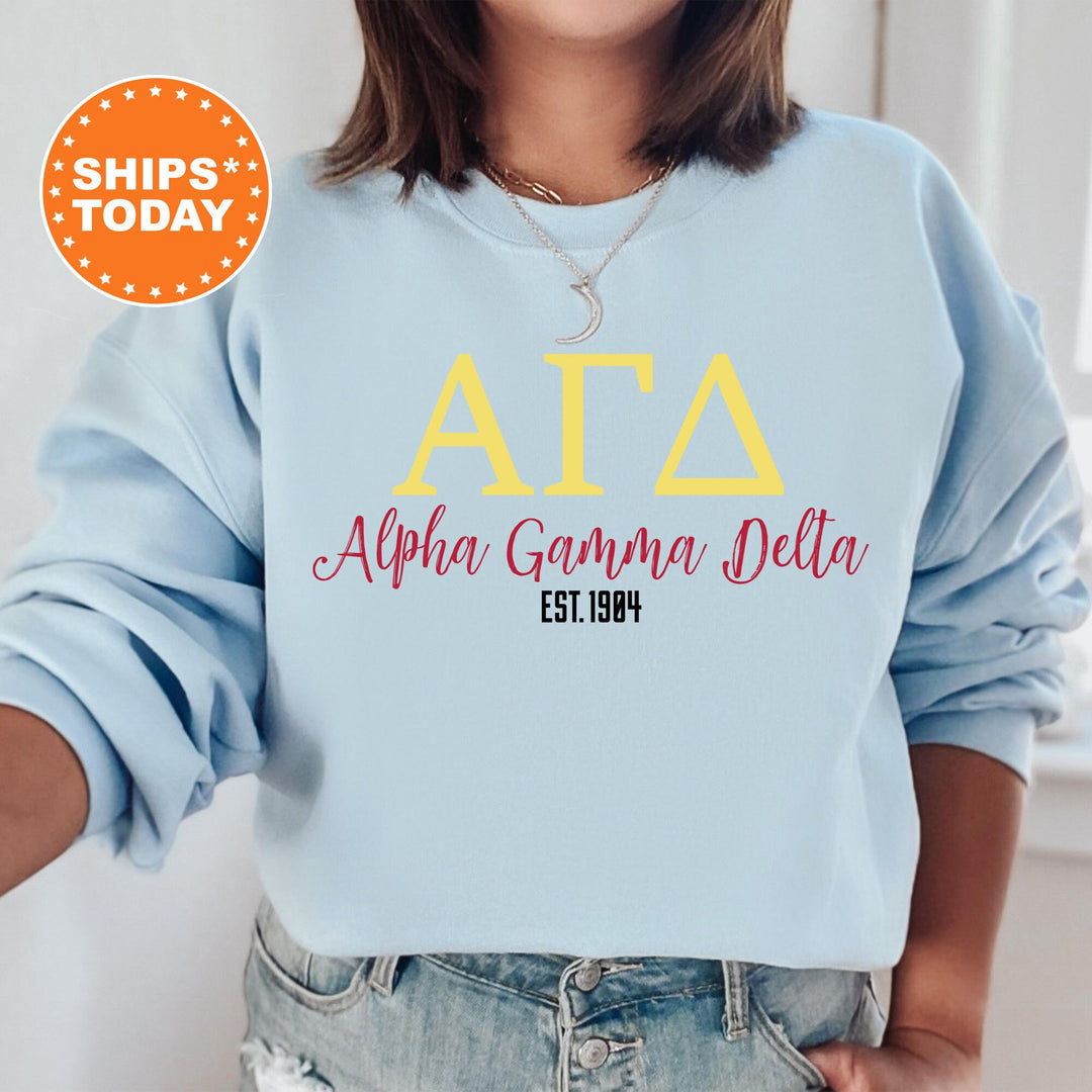 a woman wearing a light blue sweatshirt with the letters ata and delta on it