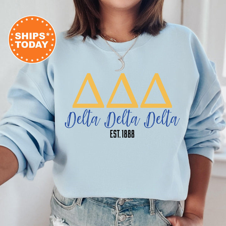 a woman wearing a sweatshirt with delta delta delta letters on it