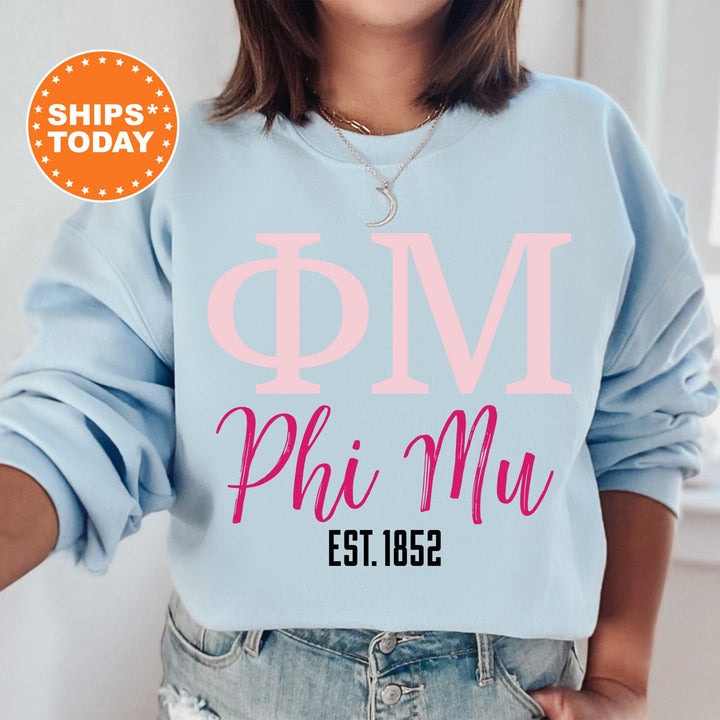 a woman wearing a sweatshirt that says phi mu