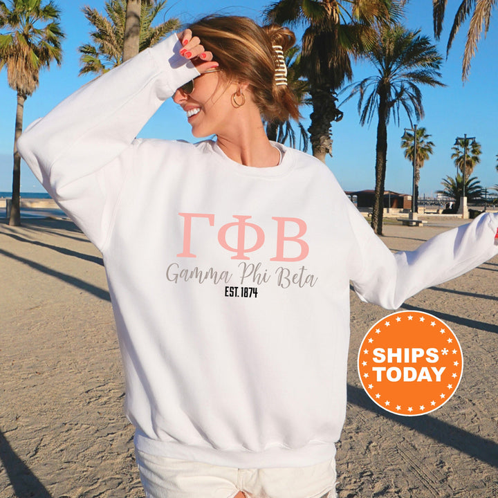 a woman wearing a white sweatshirt and white shorts on the beach