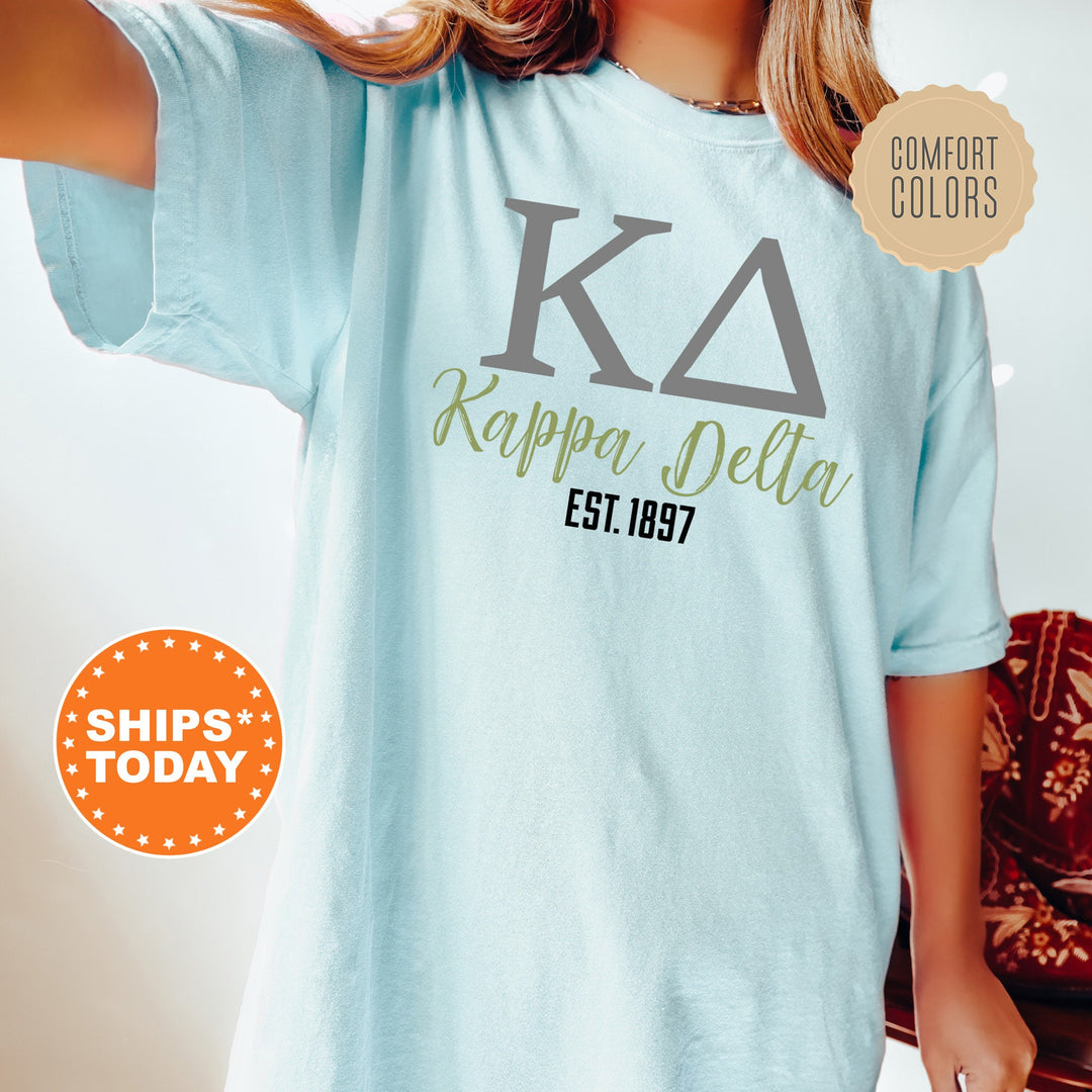 a woman wearing a blue shirt with the letters karppaa delta on it