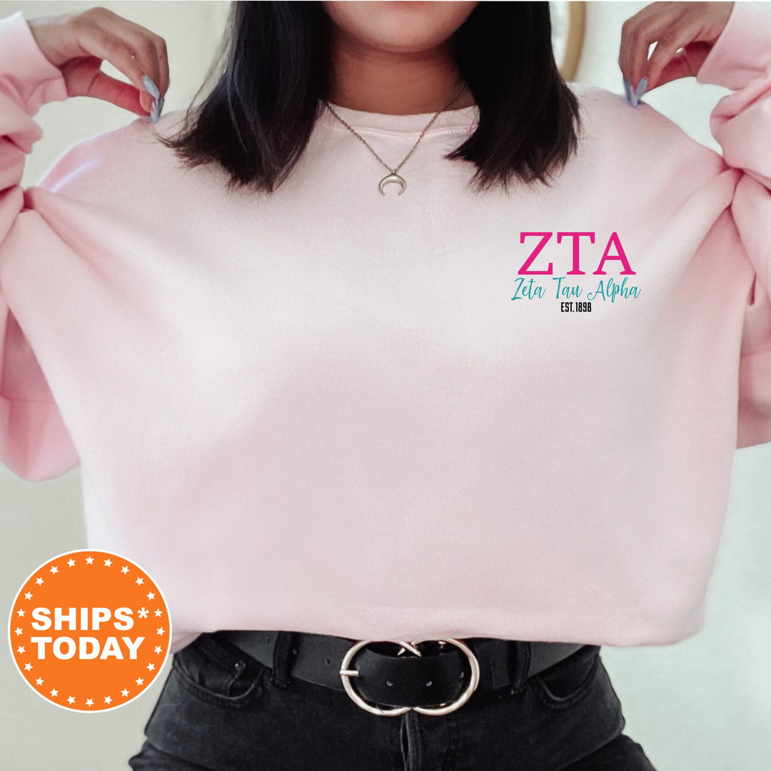 a woman wearing a pink sweatshirt with the words zta on it