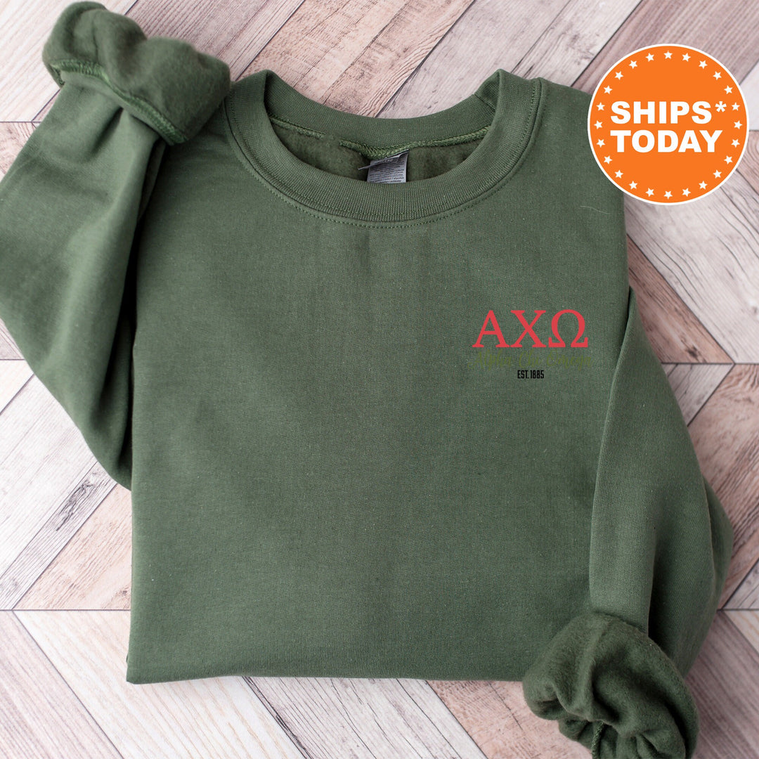 a green sweatshirt with a red axq embroidered on it