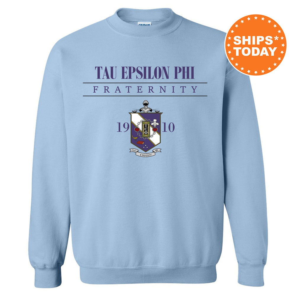 a light blue sweatshirt with the words tau epsion phi fraternity on it