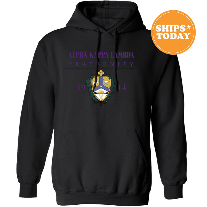 a black hoodie with a purple and yellow crest on it