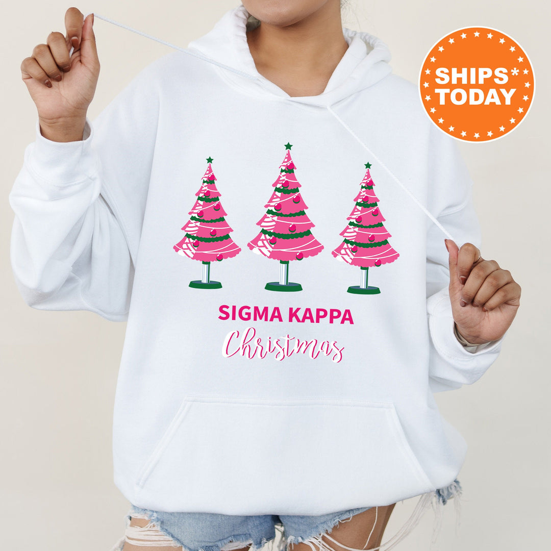 a woman wearing a white sweatshirt with three christmas trees on it