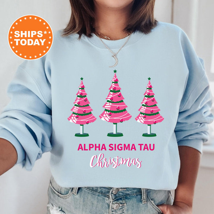 a woman wearing a sweatshirt with three christmas trees on it